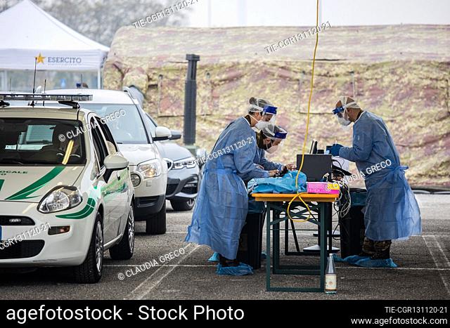 Military and army health workers while take a swab in the drive through area of Novara street car park , Milan, ITALY-13-11-2020