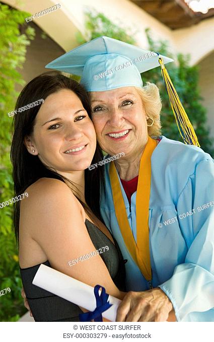 Senior graduate hugging granddaughter outside portrait