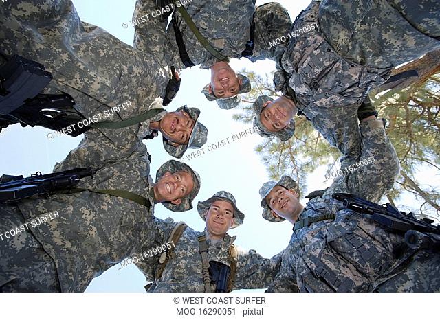 Low angle portrait of soldiers standing in circle