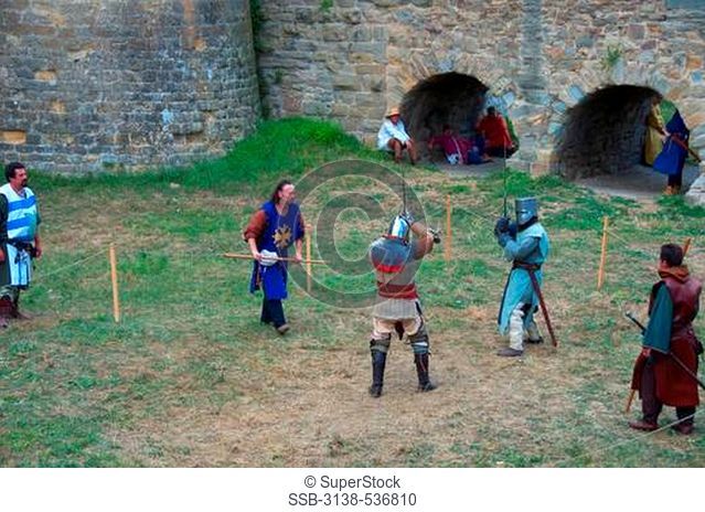 People in warriors' costumes in a fortress, Carcassonne, Aude, Languedoc-Rousillon, France