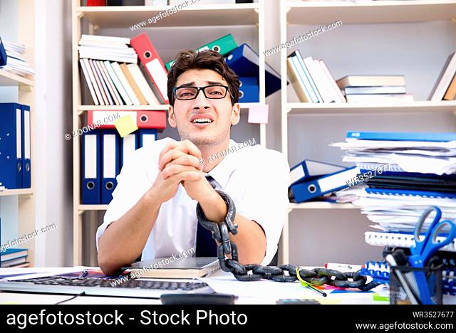 Employee attached and chained to his desk with chain