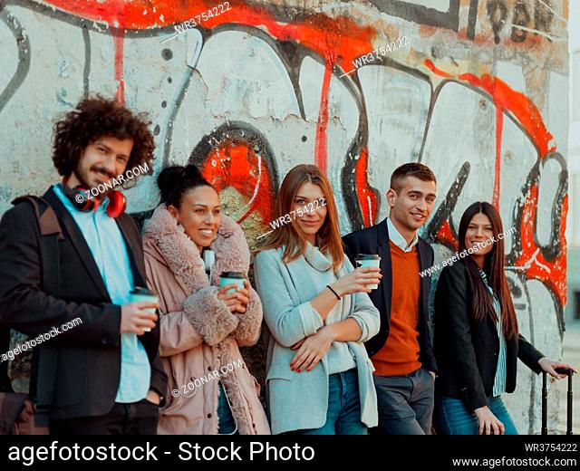 a group of diverse young businessmen on a break from work walk around the city, use smartphones, listen to music, and have fun