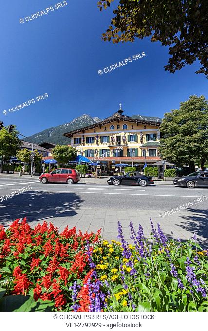 The typical hotels surrounded by peaks and colorful flowers Garmisch Partenkirchen Oberbayern region Bavaria Germany Europe