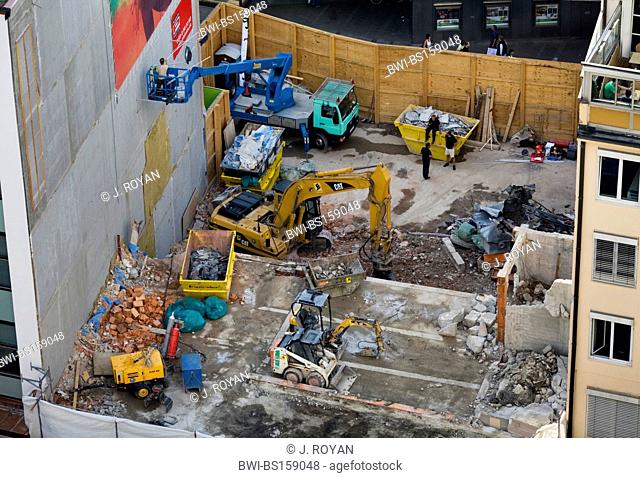 View of a demolition site and beginning of a new building with bulldozers, Germany, Muenchen
