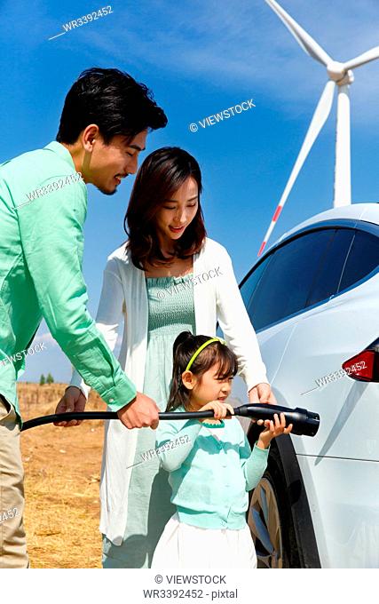 Happy family to car battery