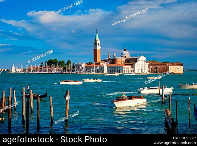 VENICE, ITALY - JUNE 27, 2018: Taxi boats in  the lagoon of Venice by Saint Mark (San Marco) square with San Giorgio di Maggiore church in background in Venice