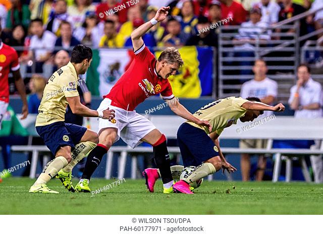 Manchester United's Bastian Schweinsteiger competes for the ball against Club America's Osvaldo Martinez (R) during the soccer friendly match between Manchester...