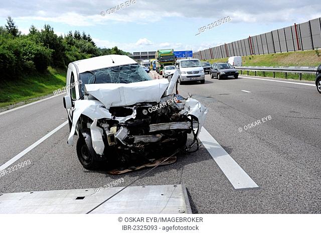 A heavily damaged van is recovered after an accident on the A8 road near Leonberg by a tow truck, Baden-Wuerttemberg, Germany, Europe