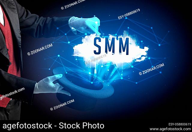 Magician is showing magic trick with SMM abbreviation, modern tech concept