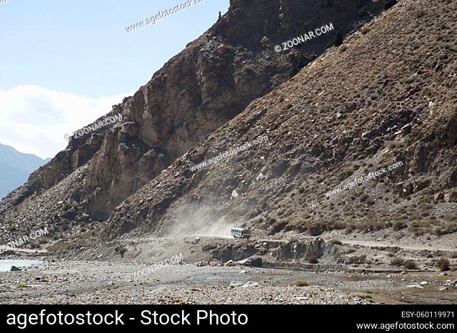 Annapurna Region, Nepal - November 03, 2014: A bus driving on a dust road on the famous Annapurna Circuit