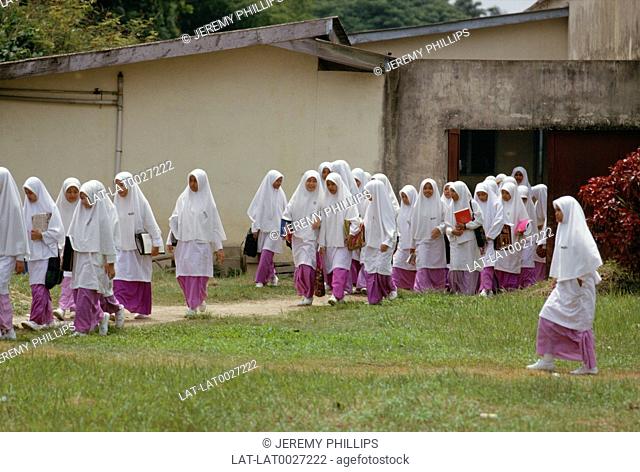 The main religion in Malaysia is Islam and female Muslim pupils at school wearing veils and cover their heads at a certain age