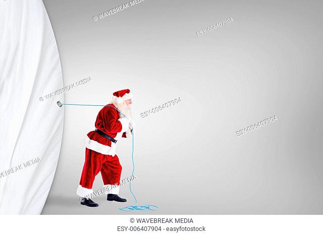 Composite image of santa claus pulling rope