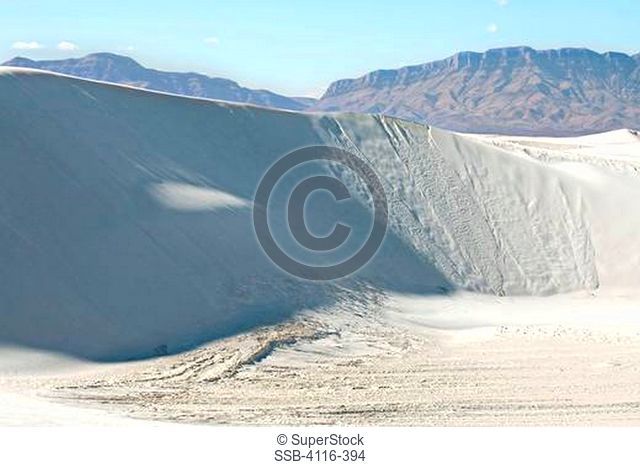 Gypsum sand dunes in a desert with mountains, White Sands National Monument, New Mexico, USA