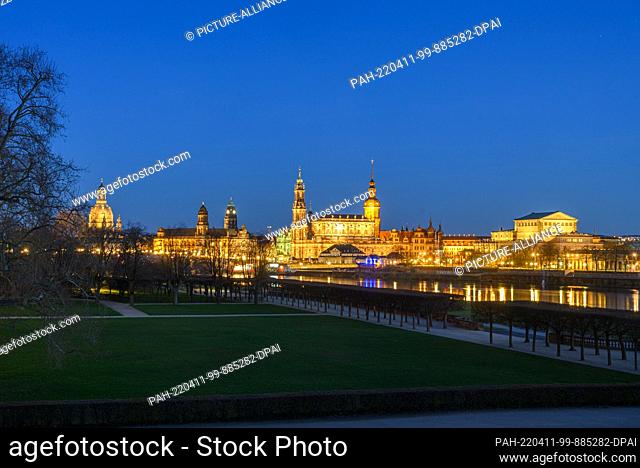 11 April 2022, Saxony, Dresden: View in the evening over the park of the Japanese Palace to the Old Town with the Frauenkirche (l-r), the Ständehaus