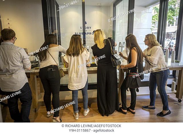 Visitors partake in Irving Farms brand cold brew coffee in the Blue Apron pop-up shop in the Chelsea neighborhood of New York on opening day, Tuesday, May 29
