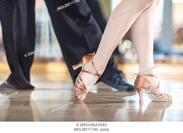 Feet of dancing couple in studio