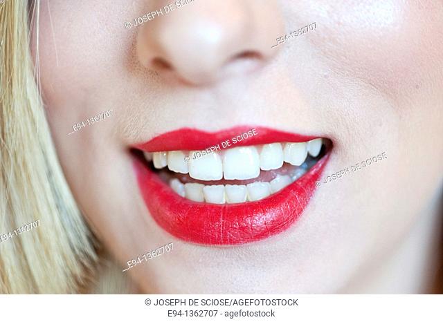 Close up of red lips and mouth of a young woman