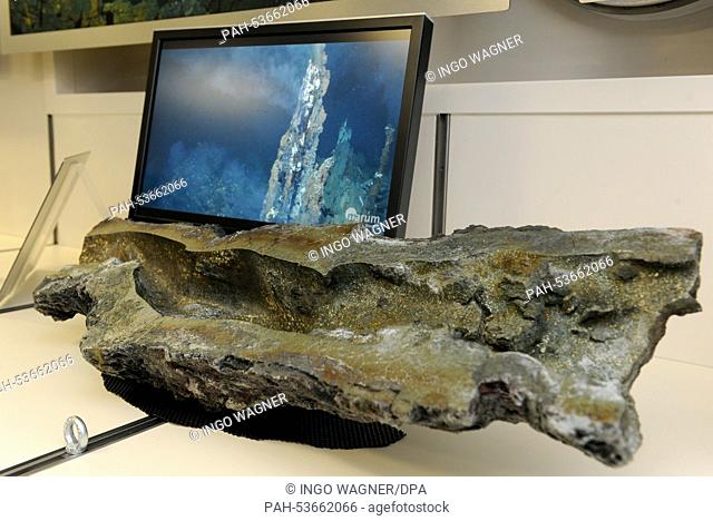 A cut of the small deep sea volcano 'black smoker' (massive sulfide) from a depth of 3, 200m in the Edmond hydrothermal field on display in the raw material...