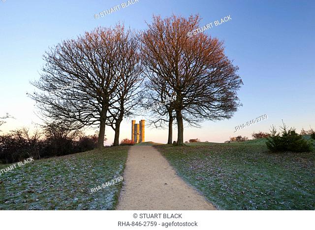 Broadway Tower framed by trees in winter frost at sunrise, Broadway, Cotswolds, Worcestershire, England, United Kingdom, Europe
