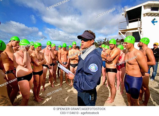 Wearing rubber caps with their classification numbers, teen applicants of both sexes for summer lifeguard jobs in Laguna Beach