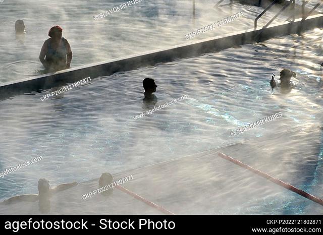 People enjoy swimming in pool with mineral springs water of Hotel Thermal during cold winter in Karlovy Vary (Spa), Czech Republic, December 18, 2022