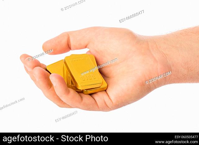 Hand with gold bars isolated on white background