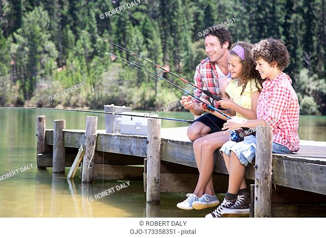 Family fishing off dock