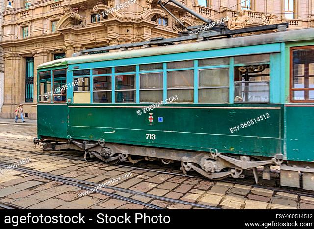 MILAN, ITALY, JANUARY - 2018 - Urban street scene with old train crossing the street at historic center of milan city, Italy