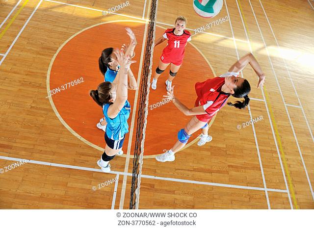 volleyball game sport with group of young beautiful girls indoor in sport arena