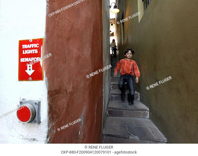 A boy descents steps of the Prague's narrowest street on Sunday, April 12, 2009 The street is fewer than 50 centimetres wide and thus must be operated by...