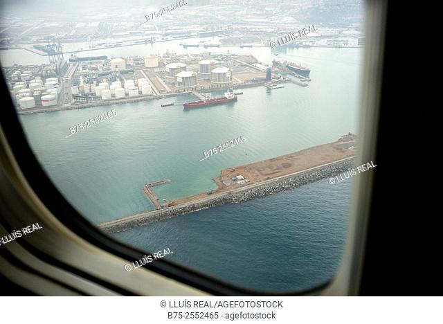 Aerial view of the commercial port of Barcelona seen from the window of an airplane. Barcelona, Spain, Europe