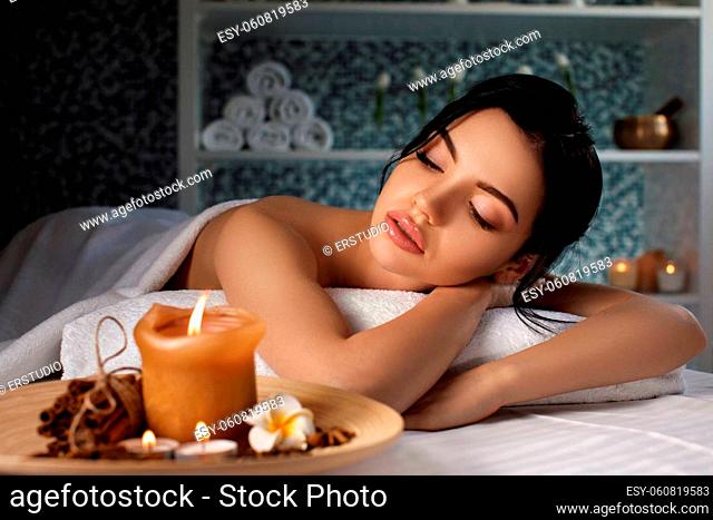 Relaxed beautiful young woman in spa salon. Beauty treatment