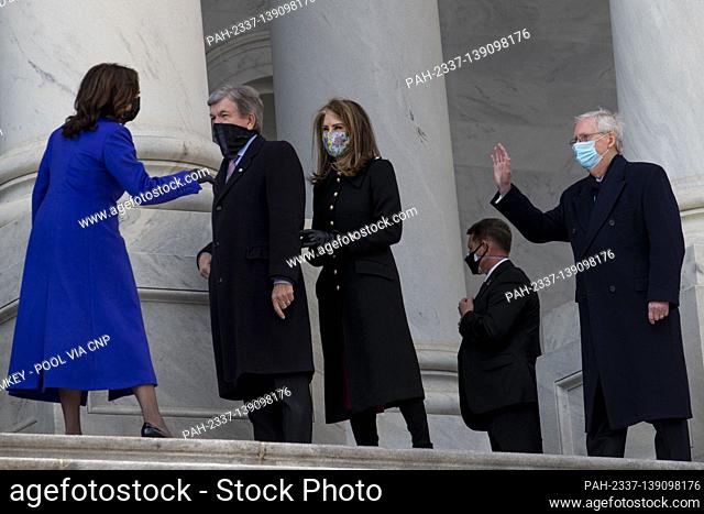 Vice President Kamala Harris, left, chats with United States Senator Roy Blunt (Republican of Missouri), second from left, his wife Abigail Perlman Blunt