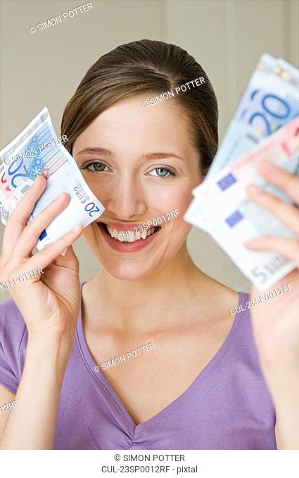 Portrait of happy woman holding money