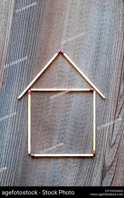 An image of a simple house of match sticks