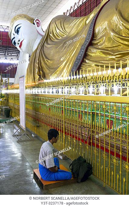 Myanmar (formerly Burma). Yangon (Rangoon). The Kyaukhtatgyi Pagoda is home to a large 70 meter long lying Buddha. His feet plants bear the 108 sacred marks...