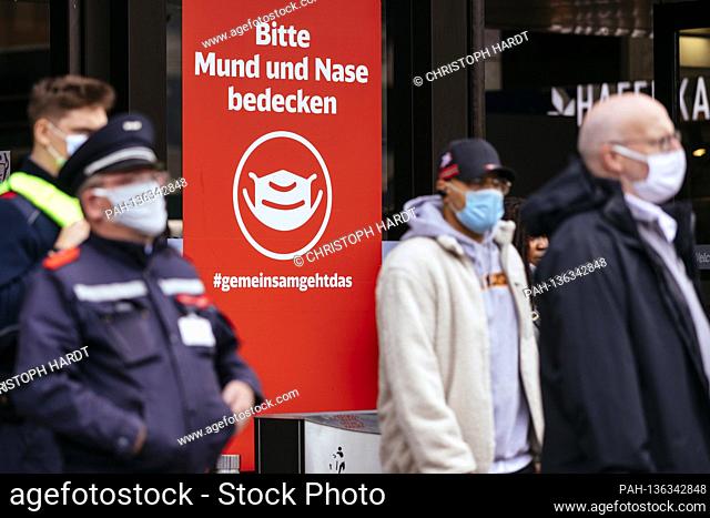 At the main train station in Dusseldorf, Deutsche Bahn signs urge travelers to 'Please cover your mouth and nose'. In pedestrian areas and in public spaces