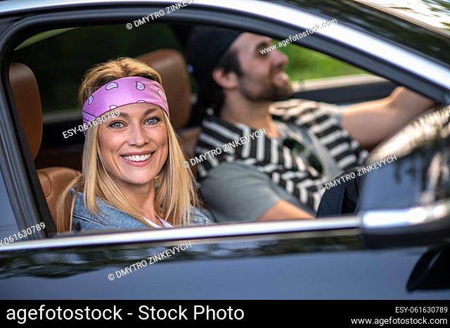 Good mood. A couple in the car looking happy and cheerful