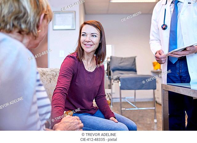 Doctor talking with patients in doctors office