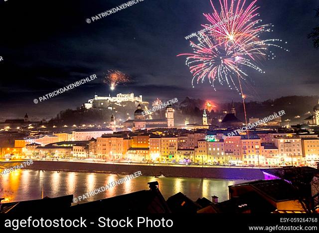 Colorful firework in the night: Old city of Salzburg and Festung Hohensalzburg at New Year’s Eve. Magic