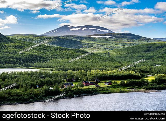 Green forested hills surrounding Karasjohka river in summer