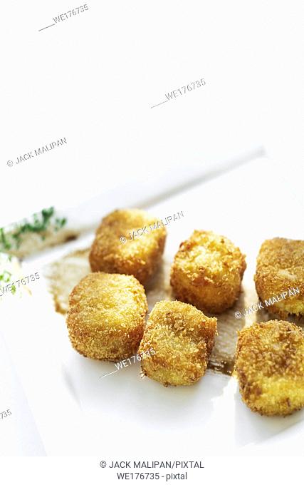 fried mashed potato square croquettes simple vegetarian side dish on white plate