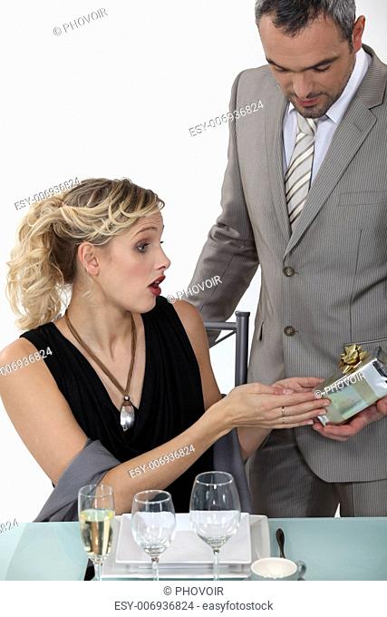 Surprised woman receiving a gift from her boyfriend