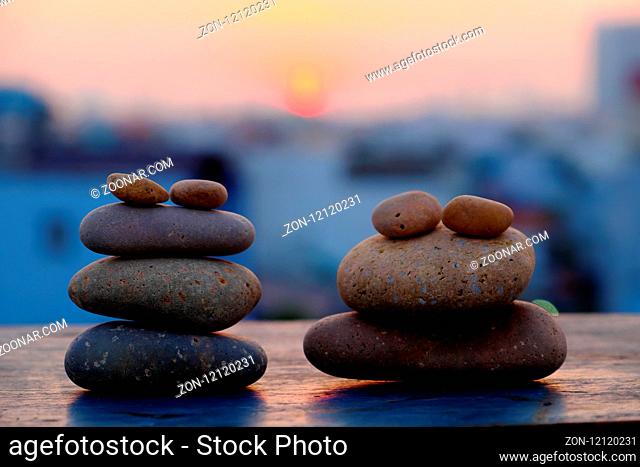 Arrangement art from boulder make amazing shape as frog couple on sunrise sky, yellow sun and pebble stone in silhouette