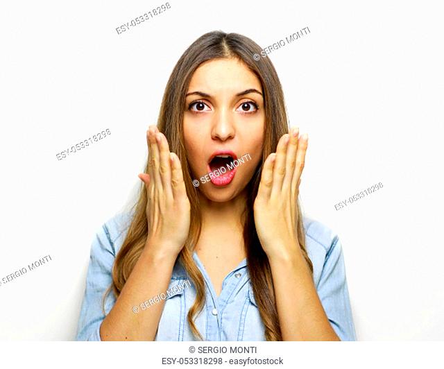 Stressed young woman with hands on face standing and shouting over white background