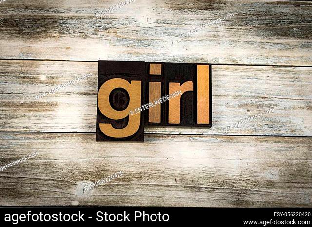 The word ""girl"" written in wooden letterpress type on a white washed old wooden boards background