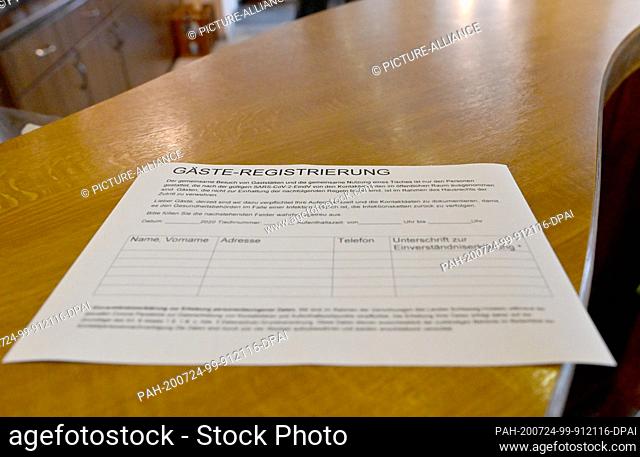 ILLUSTRATION - 24 July 2020, Schleswig-Holstein, Nortorf: A slip of paper for guest recourse is placed on a table in a restaurant