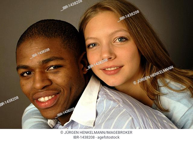 Young mixed race couple, black and white skin color, African and European, teenagers, smiling