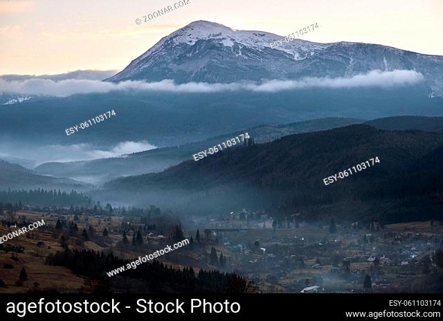 Picturesque morning above late autumn mountain countryside. Ukraine, Carpathian Mountains, Petros top in far. Peaceful traveling, seasonal