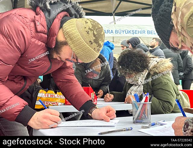 TURKEY, ANKARA - FEBRUARY 7, 2023: Donors fill out their paperwork at a mobile blood donation centre in Kizilay Square. An earthquake with a magnitude of 7